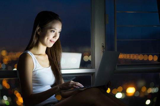 Woman using digital tablet pc at night