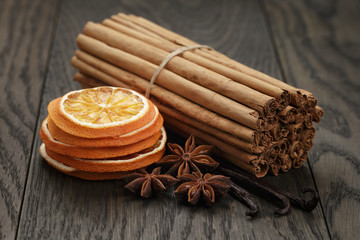 true cinnamon sticks and dried oranges, oak table