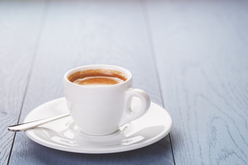Cup of fresh espresso coffee on vintage wooden table