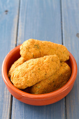 fish croquettes on dish on blue background