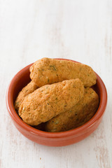 cod fish croquettes on dish on white background