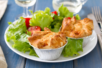 pie with chicken with salad on white plate