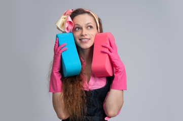 young housewife with cleaning sponge
