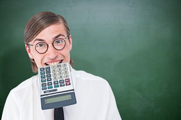 Composite image of geeky smiling businessman biting calculator 