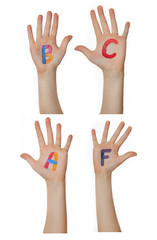 Alphabet (letters) painted on children hands.  Rises up hands. 