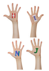 Alphabet (letters) painted on children hands.  Rises up hands. 