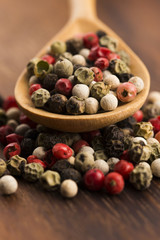 Mixed green, red, white and black peppercorns