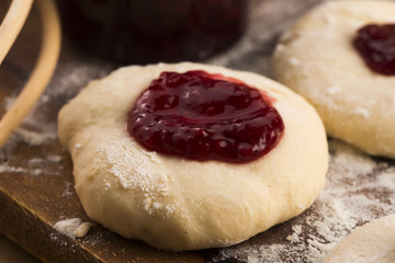 Dough with marmelade on wooden board
