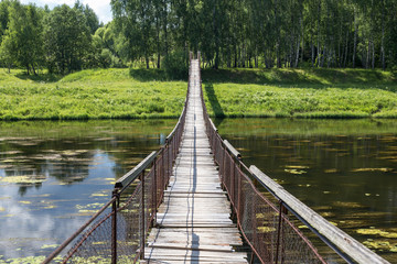 Hanging bridge. Bridge goes over river