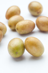 Fresh wampee fruit on white background