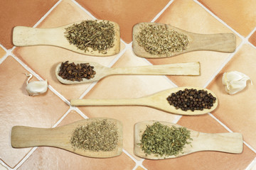 Several dried herbs used in cooking as spices: Oregano, parsley, cumin,thyme, black pepper, cloves and garlic