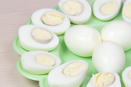 Boiled chicken eggs on a green plate