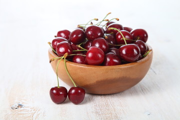 Ripe cherry in a wooden bowl