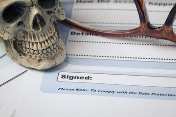Signature field on document with pen and skull signed here; docu