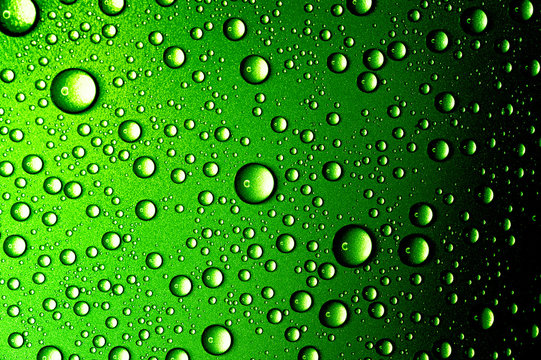 Water drops closeup. Abstract green background 