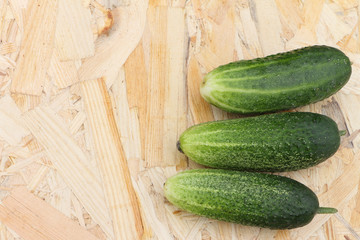 The fresh cucumbers lying on a table in a garden