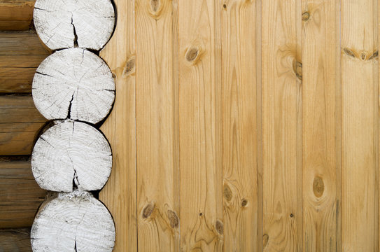 Wooden country house wall background with painted white round timber ends.