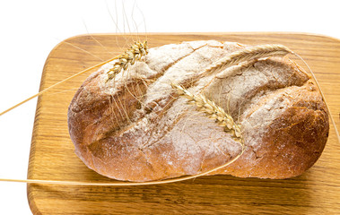 Loaf of bread on background of wood oak plate