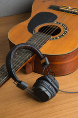 headphone and guitar on wood