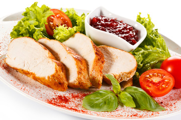 Roast chicken fillet and vegetables on white background 