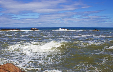 Fototapeta na wymiar Waves breaking on rocks near Dunbar Scotland