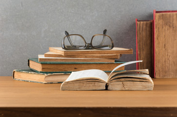 stack of books with glasses