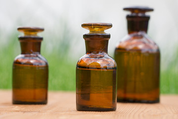 little brown bottles on booden board and grass