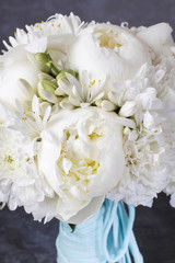 Wedding bouquet with white peonies, orchids and carnations