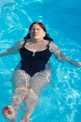 Active senior woman swimming