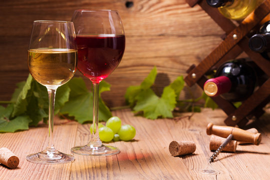 Glasses of red and white wine, served with grapes