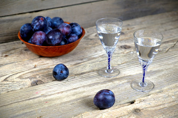 Two glasses of plum brandy with plums