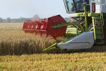 part of a combine harvester working on a wheat field