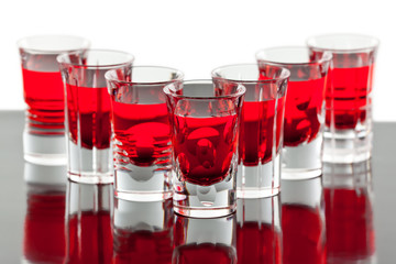 Beautiful shot crystal glasses with red liquid