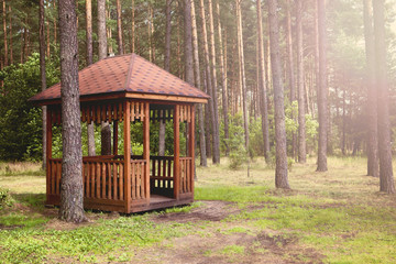A wooden gazebo in the forest