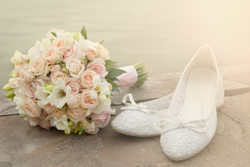 Bouquet and bride shoes closeup