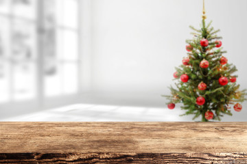 xmas tree and wooden table place in home and white wall of interior 