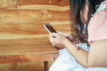 Asia women using smartphone on the bed