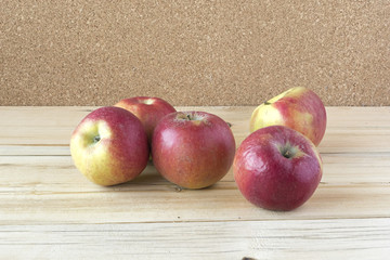 Some fresh apples on a wooden surface