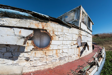 Old wooden boat with paint peeling everywhere