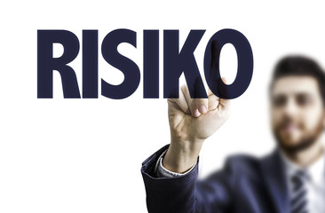 Business man pointing the text: Risk (in German)