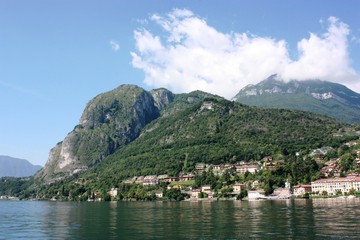 Menaggio lakefront on the shores of Lake Como under blue sky in Lombardy Italy 