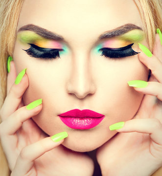 Beauty woman portrait with vivid makeup and colorful nail polish