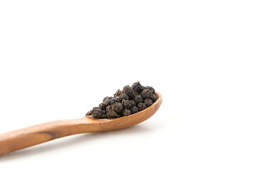 Black pepper with wood spoon