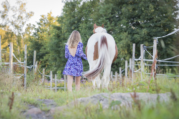 Girl with horse walking away