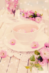 Cup of tea and beautiful fruit blossom on table