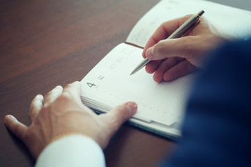 Close-up of a man working at a desk in the office.
