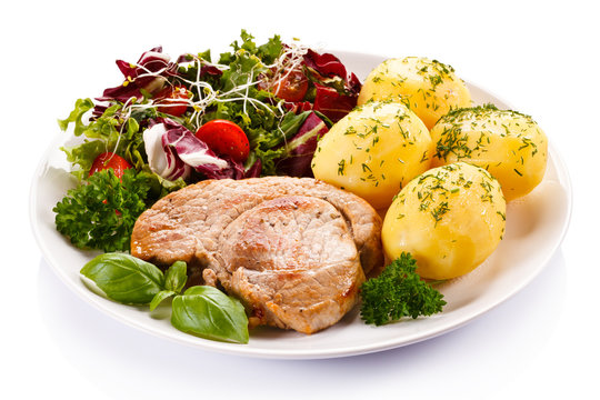 Fried steak, boiled potatoes and vegetable salad 