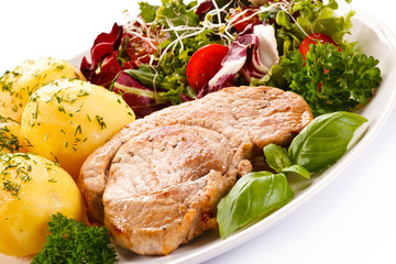 Fried steak, boiled potatoes and vegetable salad 