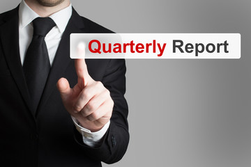 businessman pushing button quarterly report