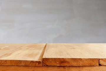 Empty wooden table and grey cement background